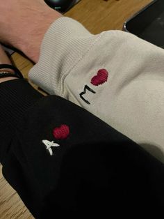 a person wearing white and black socks with red hearts on them sitting in front of a laptop