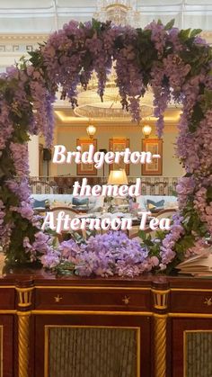 there is a sign that says bridgerton, themed afternoon tea with purple flowers on it