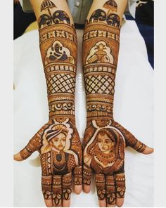 two hands with henna designs on them