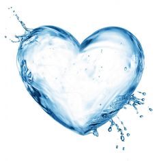 a heart shaped object floating on top of water with bubbles in the air and splashing around it