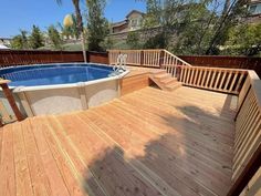 an above ground pool surrounded by wooden decking