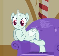 a little pony sitting on top of a purple chair