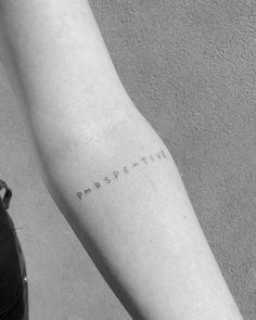 a person's arm with the word resistance tattooed on it, in black and white