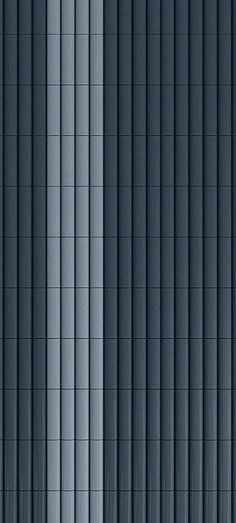 the side of a tall building with vertical blinds