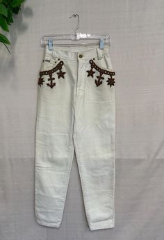 Rare / Vintage Original Escada Margaretha ley /Cream Detailed Vintage Pants Western Vibes and Cowboy Girl style Denim Boyfriend Jeans with embroidery in the front and back  Size XS (34 Italy). This is based on flat-lay measurements listed below! It is in really good condition considering its age. There are small indications of wear, simply due to natural aging. (Other, signs of fading and wear due to age) Fabric: 100% Cotton. Category: Denim Boyfriend Jeans Measurements:  Hips 34" Length 28" Waist 24" At Silkroll, we love searching for second-hand treasures. We handpick each item in the warehouse and look for quality garments that still have a second life in them. Please keep in mind that these are previously loved items and may have imperfections that add to their uniqueness. Any major fl Pants Western, Western Vibes, Cowboy Girl, Pants Denim, Jean Boyfriend, Denim Style, Vintage Pants, Jeans Boyfriend, Denim Pant