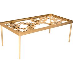 a gold coffee table with leaves on it