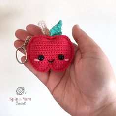 a small crocheted apple keychain with a green leaf on the top