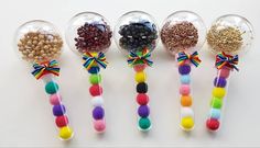 six candy lollipops with different colors and designs on them are lined up in a row