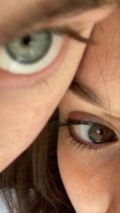 a close up of a person's eye with an object in the background