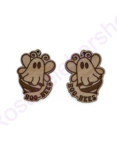 two wooden badges with an elephant on them