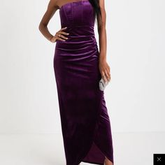 a woman in a purple dress posing for the camera