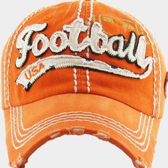 an orange baseball cap with the word football on it's front and white stitching