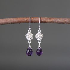 "Sweet faceted Purple Amethyst teardrops are carefully wire wrapped with silver wire onto Bali Silver rose flower links. These dangle from balled silver earwires. Wear these lightweight petite everyday to work or with your favorite jeans. Perfect for girls and women of any age. Bali Silver rose link: 7x12mm Amethyst teardrops: 5x7mm Total length of earrings: 1 1/4\" All silver is sterling. As the owner, maker, designer, and curator of this shop, I take great pride in providing you with jewelry t Nickel-free Sterling Silver Teardrop Flower Earrings, Sterling Silver Teardrop Pierced Flower Earrings, Sterling Silver Teardrop Flower Earrings, Elegant Purple Teardrop Flower Earrings, Elegant Adjustable Wire Wrapped Teardrop Earrings, Wire Wrapped Briolette Earrings For Anniversary, Wire Wrapped Teardrop Earrings For Anniversary, Adjustable Teardrop Amethyst Earrings, Purple Teardrop Wire-wrapped Earrings