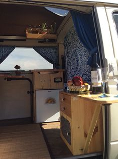 the inside of a van with an open door and small table in front of it