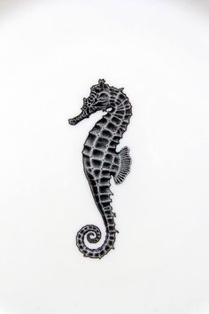 a black and white photo of a seahorse on a white background with the word,