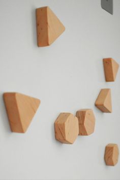 wood pieces are arranged on the wall to look like hexagons and triangles