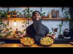 a man holding two bowls of food in his hands