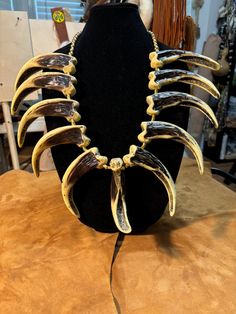 11    4 1/2" replica Kodiak bear claws made of resin, brass cones and brass beads, leather round cord. Bear Claw Necklace, Kodiak Bear, Claw Necklace, Bear Claw, Bear Claws, Brass Beads, Necklace Etsy, Accessory Gift, Electronic Accessories