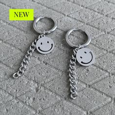 Add a touch of whimsy and fun to your outfit with these Smiley Pendant Dangle Earrings in stainless steel. These charming earrings feature cute smiley face pendants that will bring a cheerful vibe to your look. Made with high-quality stainless steel, these earrings are not only stylish but also durable, perfect for everyday wear. Whether you're dressing up for a special occasion or adding a playful element to your casual ensemble, these Smiley Pendant Dangle Earrings are sure to brighten your da Korean Fashionista, Smiley Face Earrings, Kpop Earrings, Spike Hoop Earrings, Bullet Earrings, Cute Smiley Face, Water Perfume, Titanium Jewelry, Heart Hoop Earrings