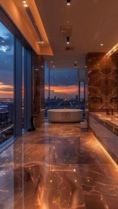 a bathroom with large windows and a bathtub in the middle of it at night