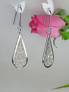 Filigree earrings made by intricate metal work, creating a dainty look. The dainty long earrings are inspired by Art nouveau jewelry combined with modern design. These art earrings sterling silver are perfect for a beloved woman, and as a pampering gift for yourself. The earrings are very flattering, comfortable to wear as a jewel for everyday use and impressive as a jewel for a special occasion. The structure of the earrings is of a dainty teardrop, approximately 25 mm long, creating an elegant and unique style. The earrings are made of 925 sterling silver by hand tools only. Each piece of jewelry is handmade to order, therefor due to the special nature of handcrafting, there may be slight differences compared to the jewelry in the photos shown. This adds to the charm and individuality of Ornate Sterling Silver Earrings With Elegant Design, Elegant Teardrop Chandelier Earrings In Sterling Silver, Elegant Sterling Silver Earrings, Dangle Filigree Bridal Earrings, Sterling Silver Filigree Chandelier Earrings For Formal Events, Sterling Silver Filigree Chandelier Earrings For Formal Occasions, Elegant Sterling Silver Filigree Earrings, Elegant Sterling Silver Filigree Teardrop Earrings, Elegant Teardrop Sterling Silver Earrings