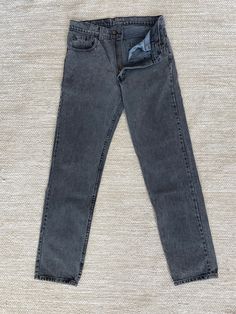 "33x34 Vntg Levis 505 Blk Gray Jeans, Vintage Jeans, Made in USA Part of our \"True Vintage Collection\" (Meaning 20 years or older) No tag to identify the year they were made  Nicely broken in jeans with measurements lying flat: Waist 16\" Front Rise 11.5\" Hip 20.5\" Thigh 11.5\" Length 43.25\" Knee 8.75\" Inseam 33\" Leg Opening 7\" Please see pics for more details.  These jeans seemed to have been altered.  Please pay close attention to the inseam measurements. Button and zipper in the front 5 pockets Made In USA 1988 100% Cotton For custom distress options please click link and add to your cart at check out:  https://www.etsy.com/listing/1138833120/custom-distressing-options?click_key=d9d473be3e769ea8a23423ddd63a5ba21b043bd4%3A1138833120&click_sum=00a53331&ref=shop_home_active_1&frs=1 Classic Washed Black Full-length Bottoms, Classic Full Length Washed Black Bottoms, Fitted Washed Black Winter Bottoms, Fitted Washed Black Bottoms For Winter, Vintage Full Length Bottoms For Winter, Vintage Relaxed Fit Pants For Winter, Washed Black Vintage Bottoms For Spring, Retro Black Bottoms For Winter, Retro Washed Black Straight Leg Bottoms