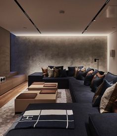 a living room filled with lots of blue couches next to a wooden coffee table