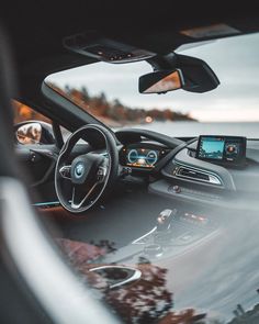 the interior of a car with dashboard lights and steering wheel, dash board, and touch screen display