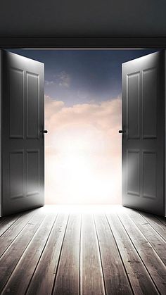 an open door leading to the sky with light coming in from behind it on a wooden floor