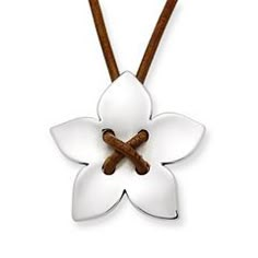 a white flower with two wooden sticks in it's center on a leather cord