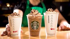 three starbucks drinks are sitting on a table