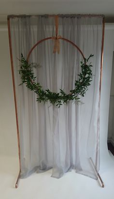 a white backdrop with a wreath hanging on it