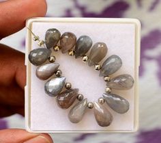 Natural Grey Moonstone Teardrop Beads Gemstone, High Quality Moonstone Faceted Beads Briolette 9-13 MM (N72) Item Code:- N72 Stone Name:- Natural Grey Moonstone Quantity:- 1 Briolette ( 13 Piece) Shape:-  Same As Picture  Measurements:- 9-13 MM Quality:-AAA++ ----------------------------------------------------------------------------------------------- Shipping: ----------------------------------------------------------------------------------------------- WORLD WIDE SHIPPING 10-21 Working days ( India Post )  UPGRADE SHIPPING  Fast shipping 19.99$ and Delivery time 6-8 Working Days International Priority Services for USA, UK, UAE, Canada, Thailand, Singapore ,Taiwan., France, Australia, Israel, Japan, Germany, Number of days to reach the parcel: 6-8 working days. ------------------------ Grey Moonstone, Teardrop Beads, Faceted Bead, Favorite Things Gift, Jaipur, Semiprecious Stones, Precious Stones, Moonstone, Gemstone Beads