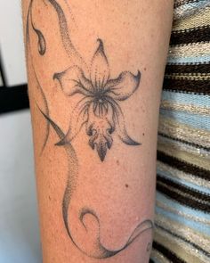 a woman's arm with a tattoo on it that has a flower in the middle