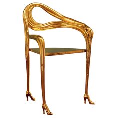 a chair made out of gold leafy wood with legs and feet on the back