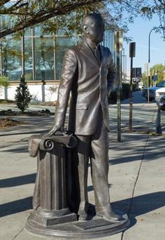 a statue of a man holding a briefcase