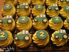 cupcakes with yellow frosting and green cars on them