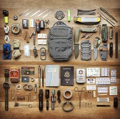 an assortment of items are laid out on a table together to be used as a survival kit