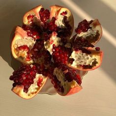 the pomegranate is cut in half and ready to be eaten