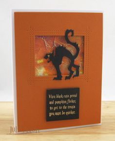 an orange card with a black cat on it