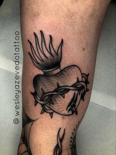 a tattoo on the leg of a person with a bird flying over it's head