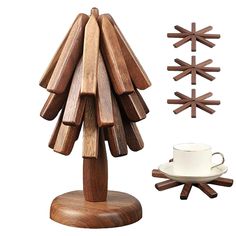 a wooden christmas tree next to a cup and saucer