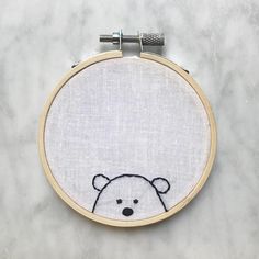 a cross stitch pattern with a teddy bear on it's face in the hoop