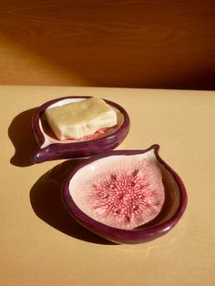 two pieces of food sitting on top of a table next to each other in bowls