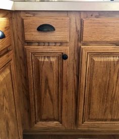 a kitchen with wooden cabinets and stainless steel sink faucet in the center area