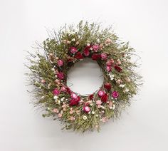 a wreath with pink and white flowers on it