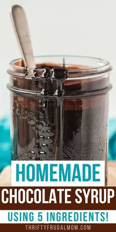 homemade chocolate syrup in a glass jar with spoon and text overlay reading homemade chocolate syrup using 5 ingredients