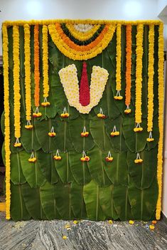 a green wall decorated with yellow and red flowers