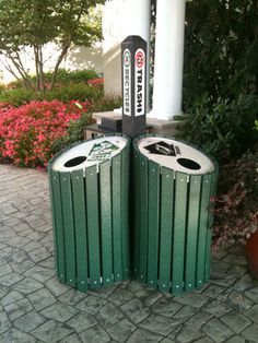 two green trash cans sitting next to each other