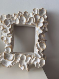 a decorative white frame sitting on top of a table